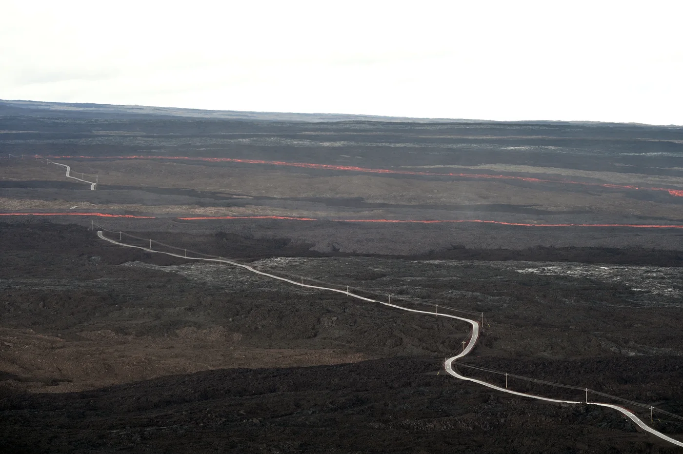 Aerial view of lava crossing the Mauna Loa Observatory Road in two places